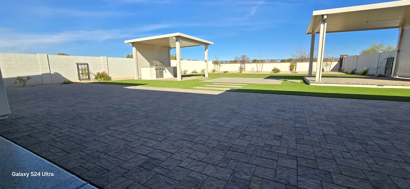 Wide paver patio with turf beyond