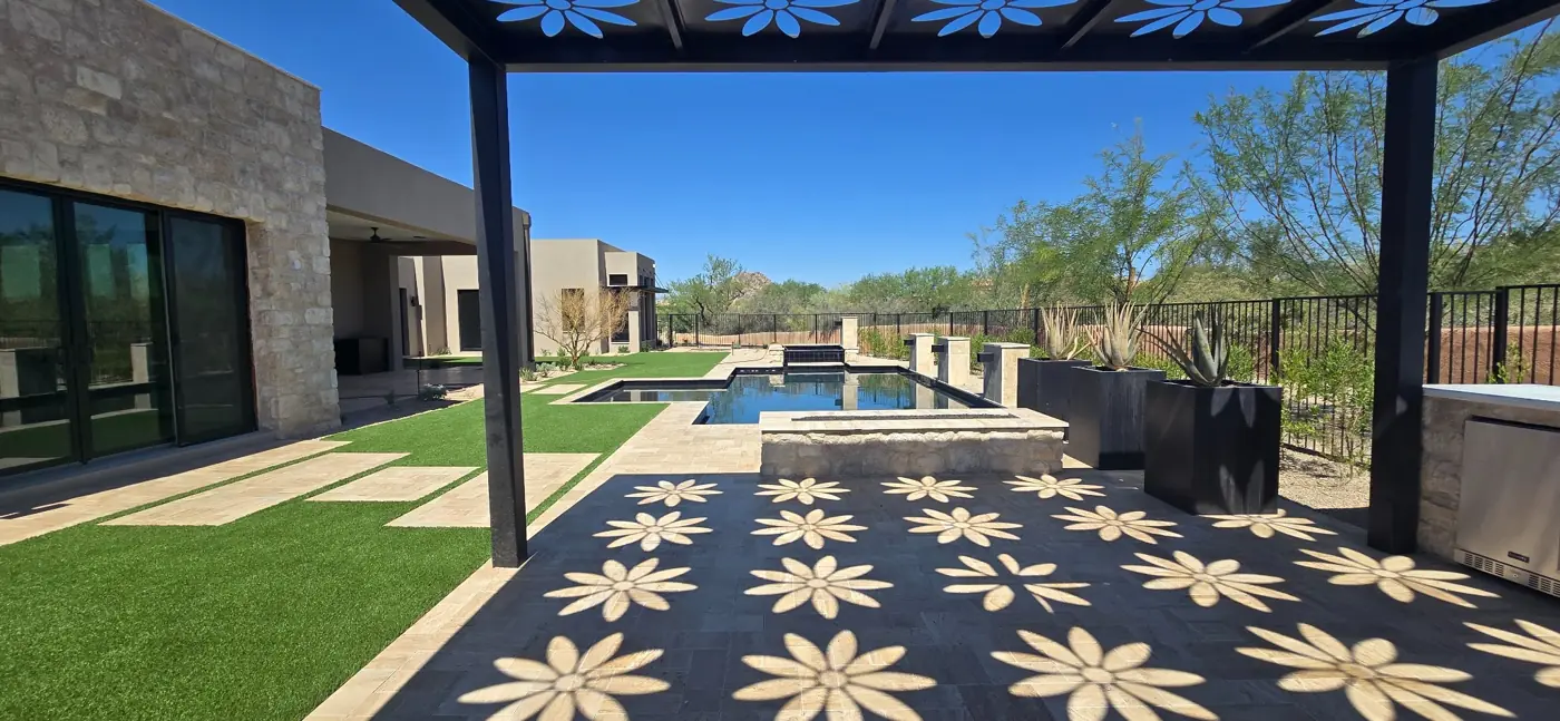Poolside entertaining beneath a pergola by L & R