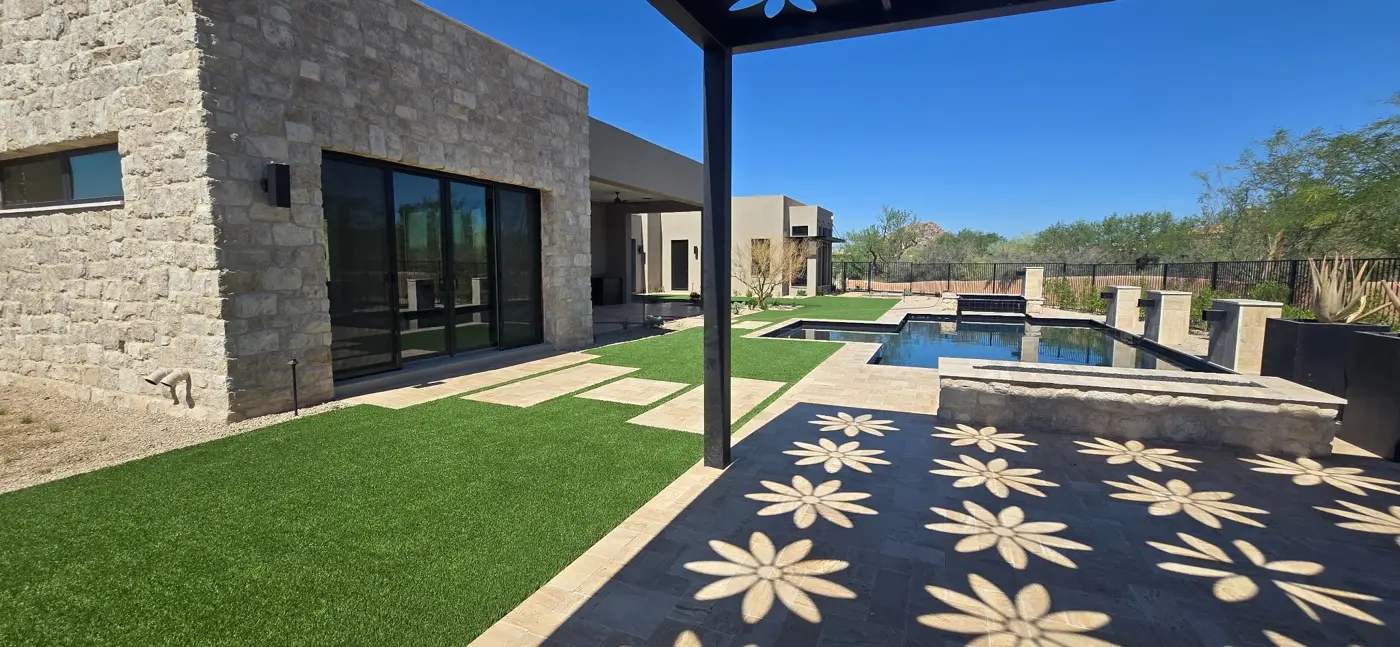 Pool and spa with a shaded patio by L & R