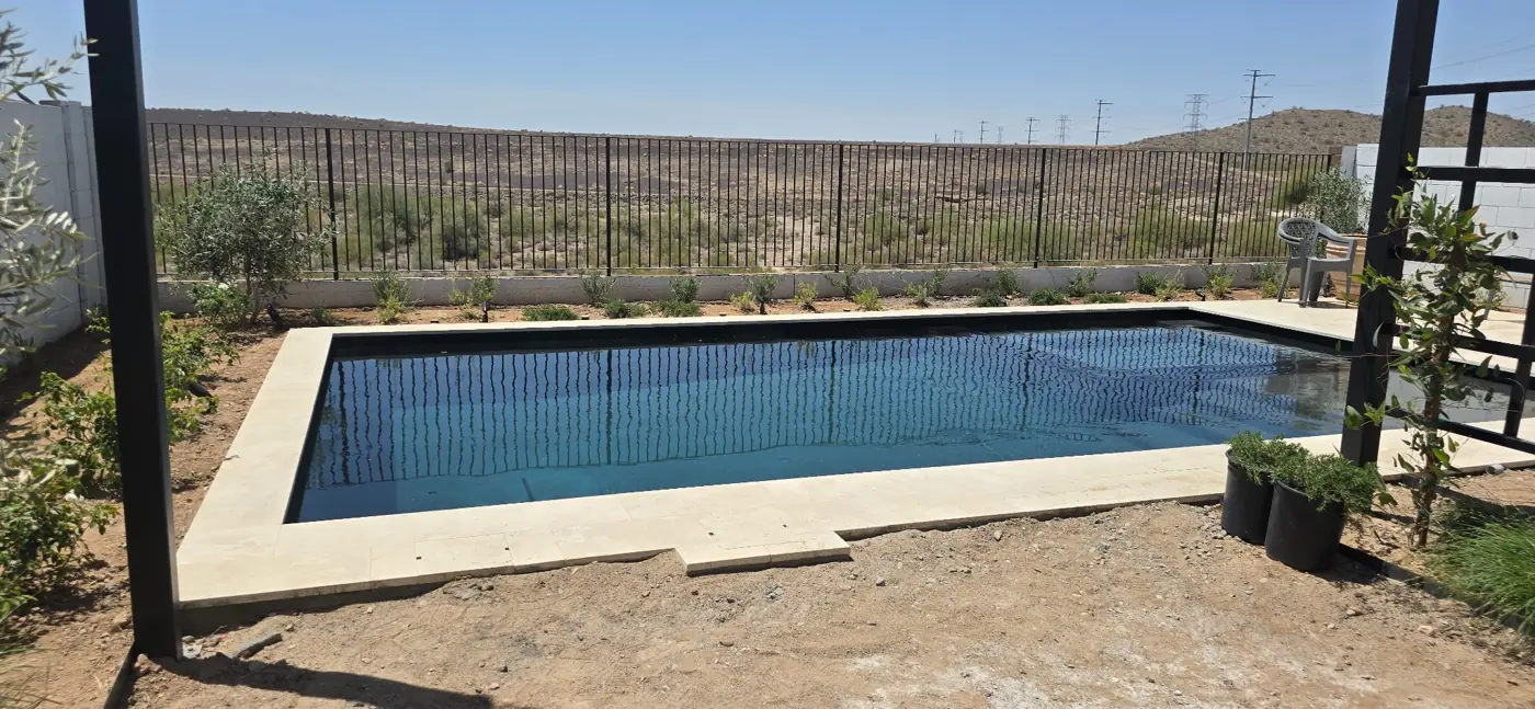 Rectangular pool with open backyard views by L & R