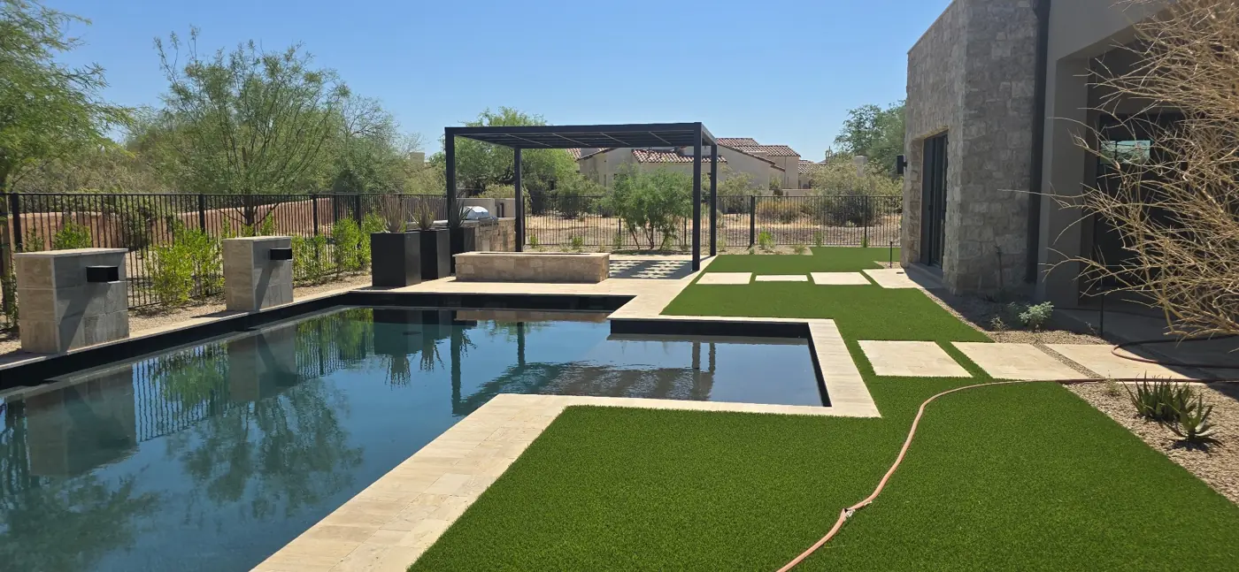 Pool and spa with turf and stepping pads by L & R
